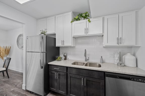 a kitchen with white cabinets and a stainless steel refrigerator at Ivy Hills Living Spaces, Ohio, 45244
