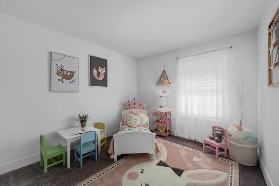 a childs bedroom with a bed and a table and chairs at Ivy Hills Living Spaces, Cincinnati