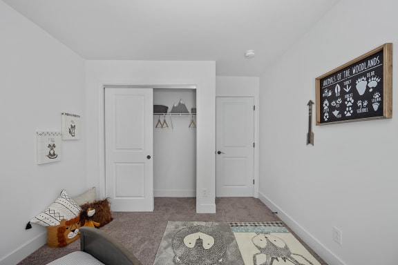 a living room with a couch and a hallway with three doors at Ivy Hills Living Spaces, Cincinnati, 45244