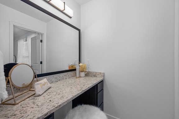 a bathroom with a large mirror and a vanity with a mirror at Ivy Hills Living Spaces, Cincinnati, OH