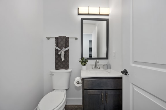 a bathroom with a toilet sink and a mirror at Ivy Hills Living Spaces, Cincinnati, Ohio
