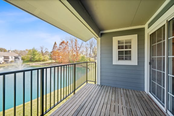 the view from the balcony of a house overlooking a lake