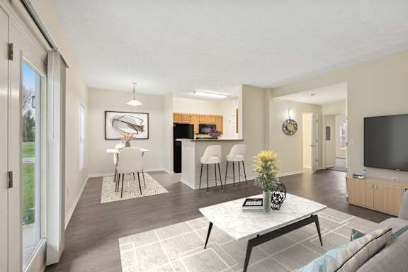 A modern living room with a white coffee table and a television.