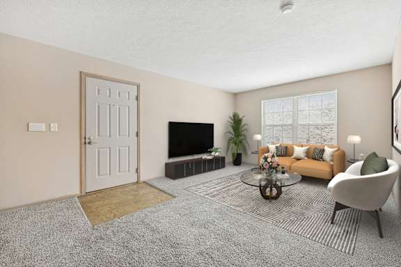 A living room with a grey carpet and a white door.