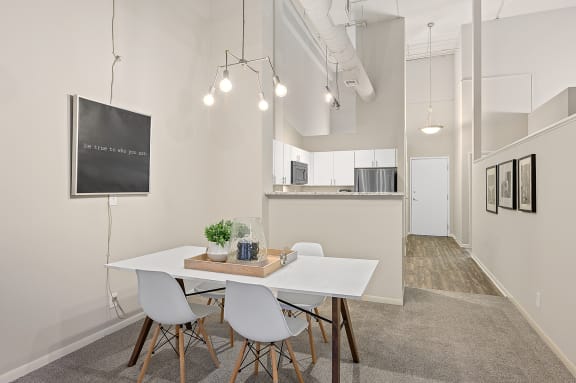 White dining table and chair at The Lofts at Shillito Place, Ohio, 45202