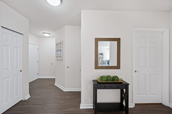 A hallway with a table and a mirror. at Roebling Row, Covington, Kentucky