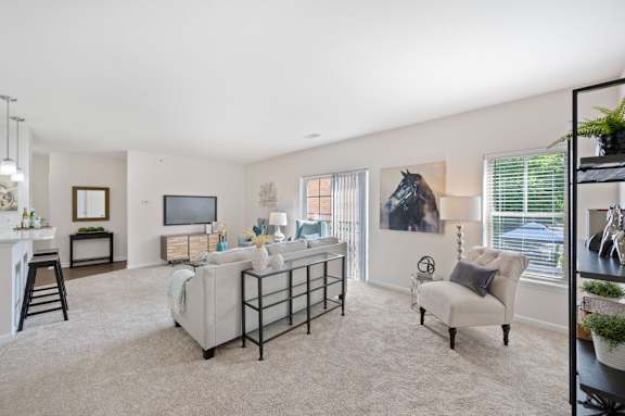 A living room with a white sofa and a TV. at Roebling Row, Covington