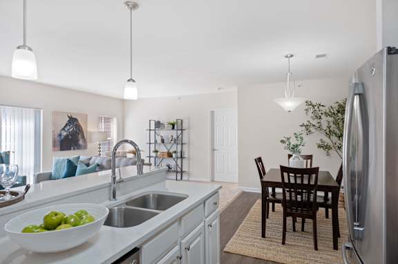 A kitchen with a table and chairs and a fridge. at Roebling Row, Covington, 41011-1720