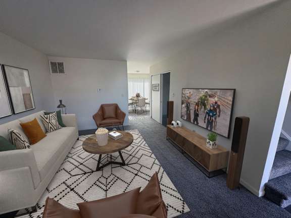 A living room with a couch, chairs, and a coffee table.