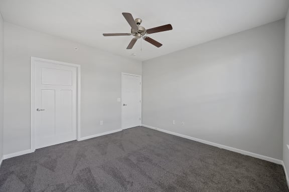 a bedroom with carpet and a ceiling fan at Monmouth Row Apartments, Newport, 41071