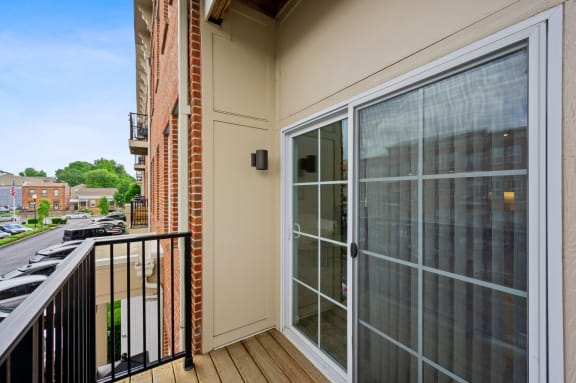 the view from the balcony of an apartment building with a glass door at Monmouth Row Apartments, Newport, Kentucky