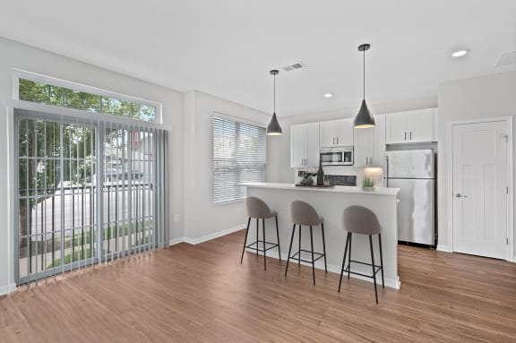 a kitchen with a bar and a sliding glass door at Monmouth Row Apartments, Newport, 41071