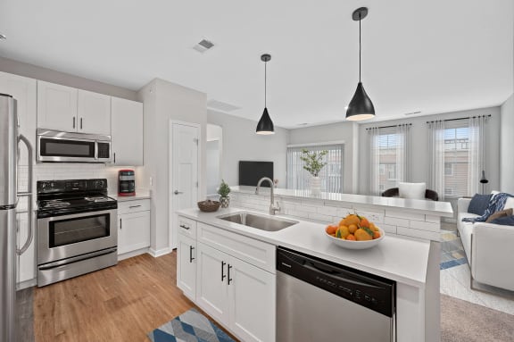 a white kitchen with a large counter top and a sink at Monmouth Row Apartments, Newport, 41071