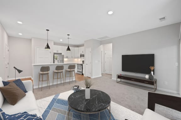 a living room with a couch and a coffee table and a kitchen at Monmouth Row Apartments, Kentucky