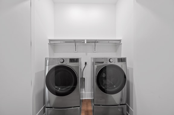 two washing machines in a white laundry room at Four23/Hoge, Ohio