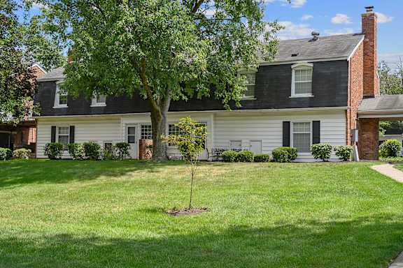 a white house with a tree in the front yard at Olde Towne in Kenwood, Ohio