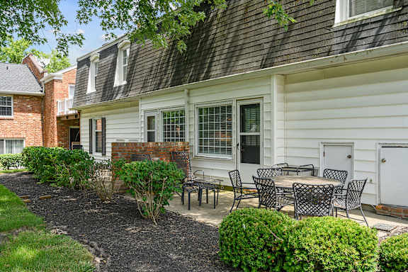 a patio with tables and chairs in front of a house at Olde Towne in Kenwood, Cincinnati