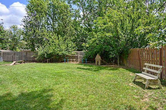 a backyard with a bench and a tree at Olde Towne in Kenwood, Cincinnati, Ohio