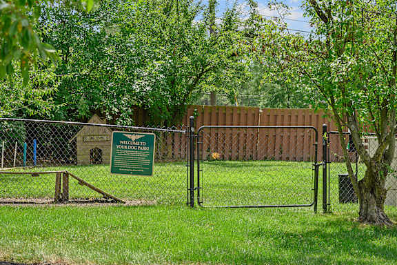 a fence with a sign on it in front of a tree at Olde Towne in Kenwood, Cincinnati, 45243