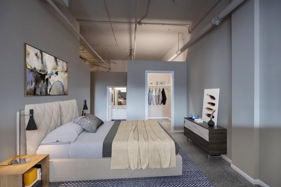 Bed in bedroom at The Lofts at Shillito Place, Cincinnati