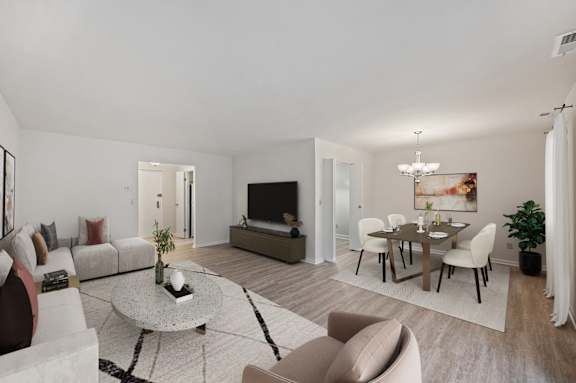 A modern living room with a grey sofa, a coffee table, and a television. at Indian Creek Apartments*, Cincinnati, OH