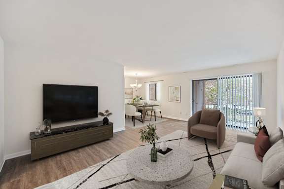 A living room with a television, a couch, a coffee table, and a chair. at Indian Creek Apartments*, Cincinnati, OH, 45236