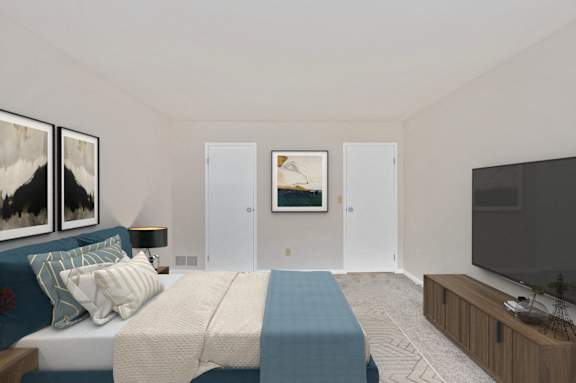 A bedroom with a bed, a couch, a television, and two framed pictures on the wall. at Indian Creek Apartments*, Cincinnati, OH