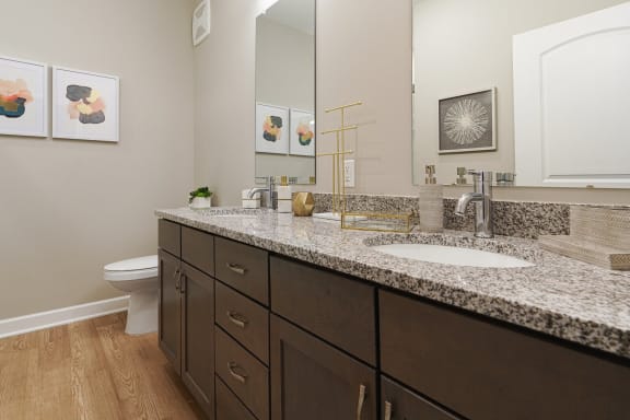 a bathroom with granite counter tops and a toilet and sink at Adelphi Quarter, Columbus, OH