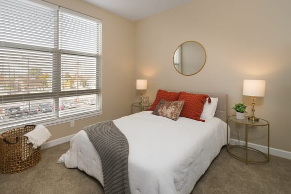 a bedroom with a white bed and two windows at Adelphi Quarter, Ohio, 43203