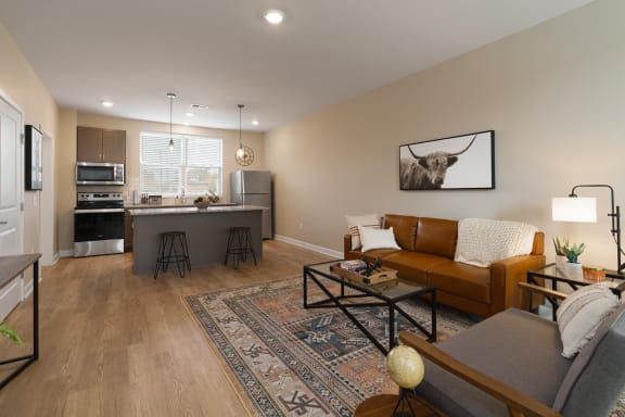 a living room with a couch and a table in front of a kitchen at Adelphi Quarter, Ohio, 43203
