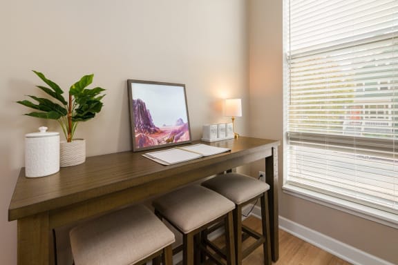 a desk with two stools in a room with two windows at Adelphi Quarter, Columbus, Ohio