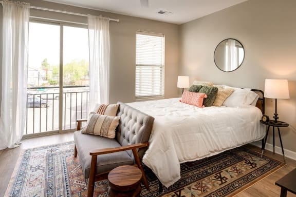 a bedroom with a bed and a large window and a rug at Adelphi Quarter, Ohio