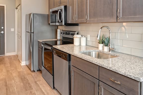 a kitchen with stainless steel appliances and a counter top at Adelphi Quarter, Columbus, OH, 43203