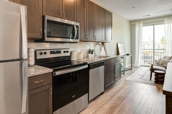 a kitchen with stainless steel appliances and wooden cabinets at Adelphi Quarter, Ohio, 43203