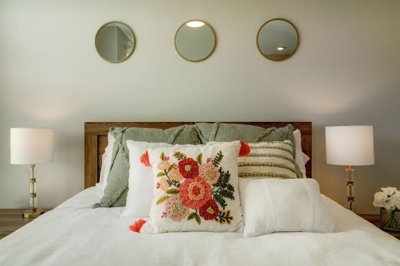 a bedroom with a bed with pillows and pillows on it and two lamps at Adelphi Quarter, Columbus, Ohio