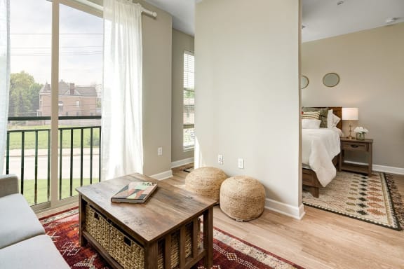 a living room with a large window and a couch and a table at Adelphi Quarter, Columbus, OH