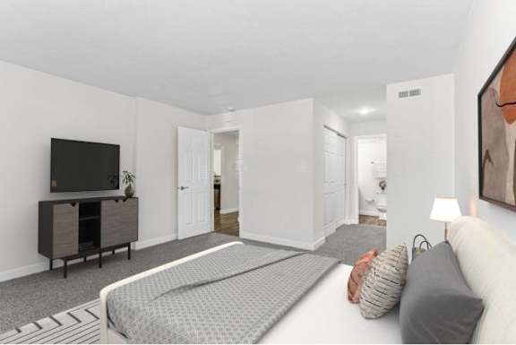 A bedroom with a bed, a television, and a cabinet.