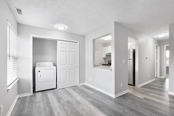 a long hallway with white doors and white floors and stairs at Parkview of Lebanon Apartments, Lebanon, IN