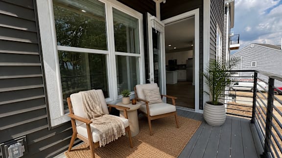 A patio with two chairs and a table.
