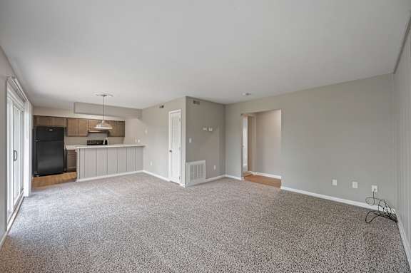A spacious living room with a television and a bar area.