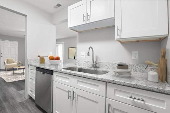 a kitchen with white cabinets and a stainless steel sink at Parkview of Lebanon Apartments, Indiana