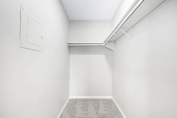 A white room with a carpeted floor and a white ceiling.