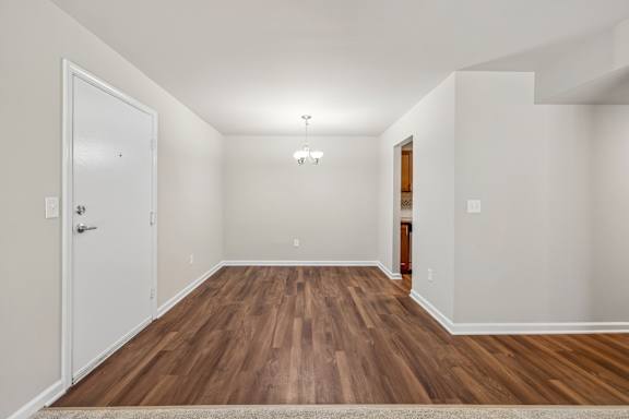A room with wooden floors and white walls.
