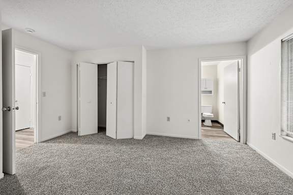 A room with a carpeted floor and white walls.