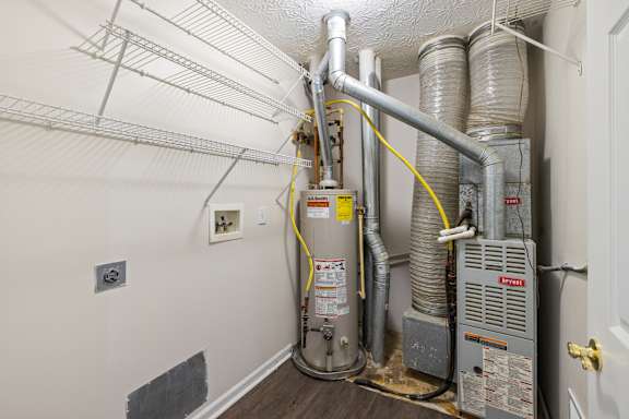 A room with a furnace and ductwork.