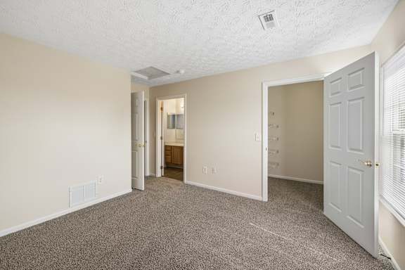 A room with carpeted floor and white walls.