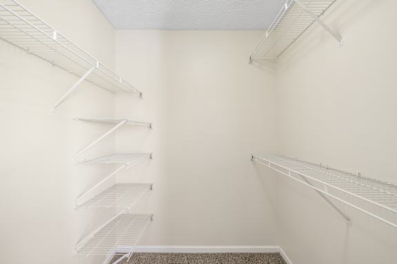 Empty white shelves in a room.