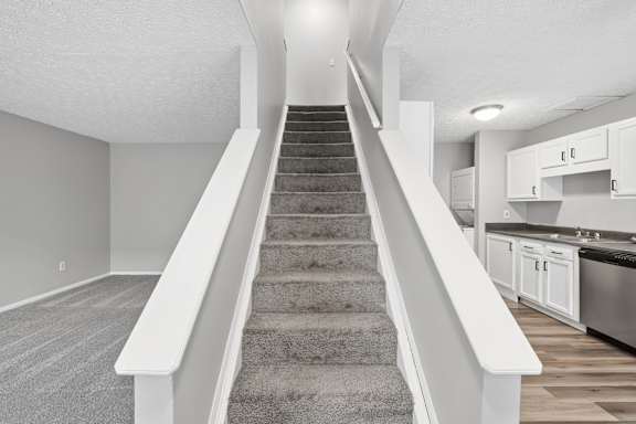 staircase with a carpeted runner at Timbercreek Apts, Columbus, 43207
