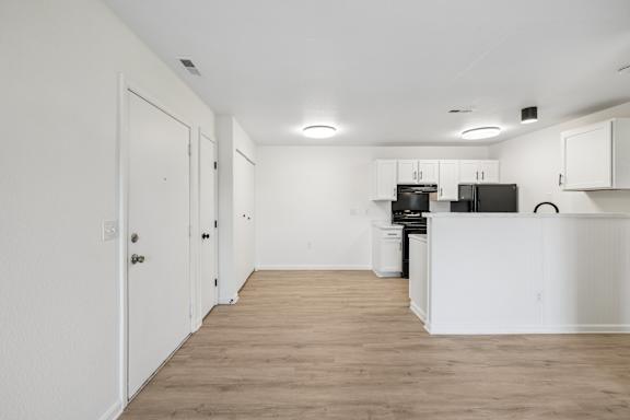 A kitchen area with a refrigerator, dishwasher, and oven.