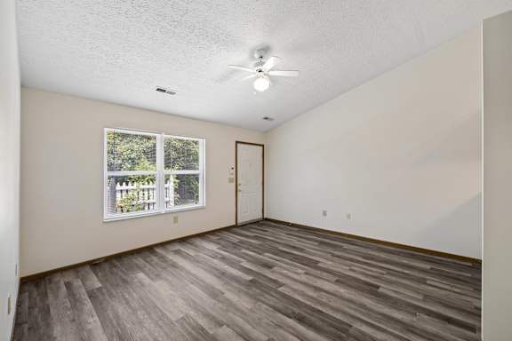 A room with a window and a ceiling fan.